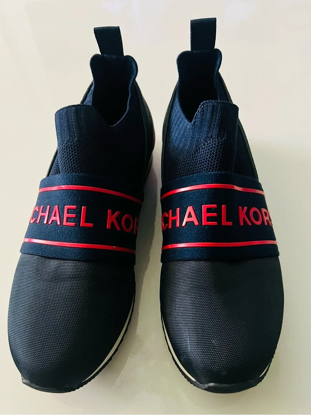 Michael Kors Women’s Blue Slip-On Sneakers with Red Logo Band